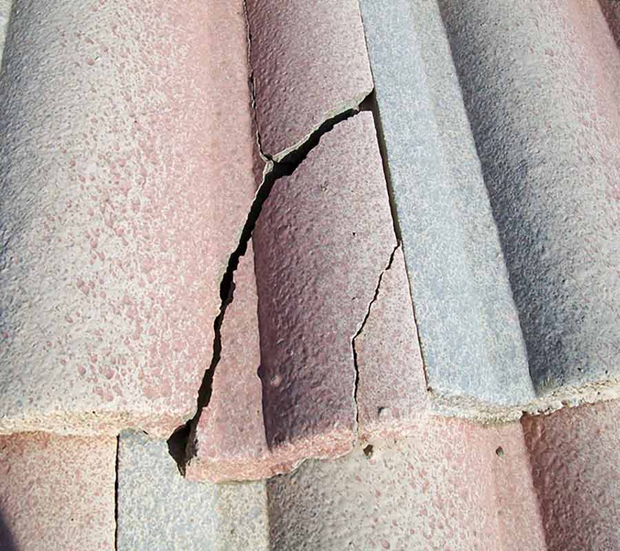 Concrete tile roof leak being inspected