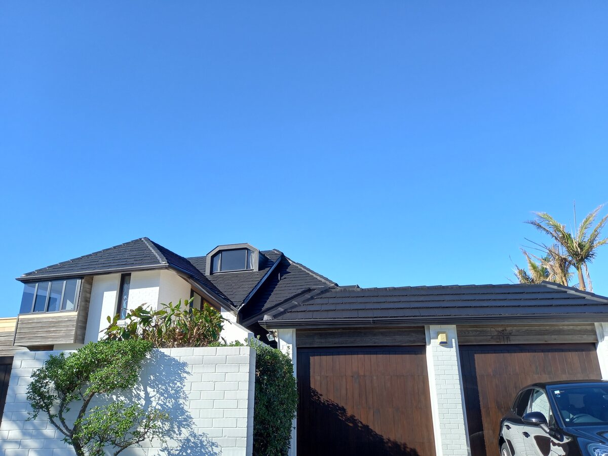 Completed Roofcare concrete tile roof in Midnight on a modern Auckland home