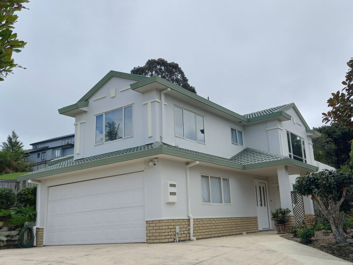 Completed Roofcare concrete tile roof in Mist Green on a two storey Auckland home